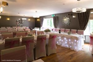 a set of tables and chairs in a room at Twin Oaks Hotel in Chesterfield