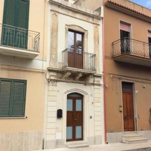 un edificio con dos balcones y una puerta en Tonsorim Affitti brevi, en Avola