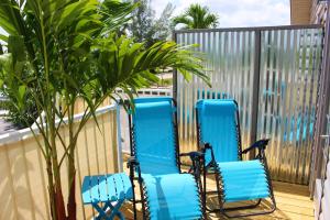 a pair of blue chairs sitting on a balcony at Latitude 26 Waterfront Boutique Resort - Bonita Springs in Bonita Springs