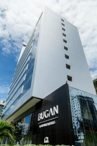 a large building with a clock on the front of it at Bugan Recife Hotel by Atlantica in Recife