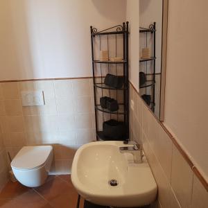 a bathroom with a white toilet and a sink at Agriturismo La Fonte in Grosseto