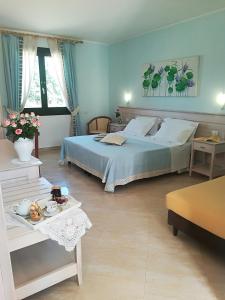 a blue bedroom with a bed and a table at Agriturismo Torrevecchia in San Pancrazio Salentino