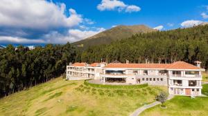 an aerial view of a large building on a hill at Hotel Medina Del Lago in Otavalo