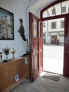 an open door with a statue of a woman on the wall at Pension Bergmann-Welp in Freiberg