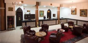 a waiting room with leather chairs and a table at Hôtel Rif in Meknès