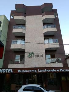 a hotel with a car parked in front of it at Vital Hotel in Marechal Floriano