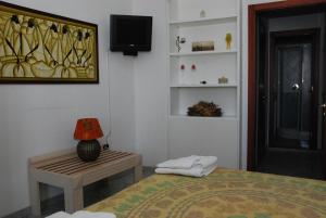 a bedroom with a bed and a table and a tv at B&B Martius 2 in Martano