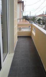 a balcony with a tile floor and a window at BEM ME QUER 1 in Almada