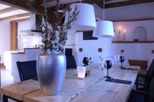 a wooden table with a vase with flowers in it at Die Mühle Appartements in Samtens