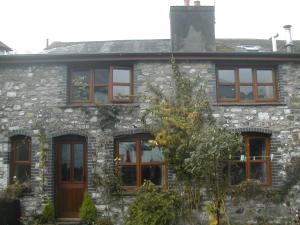 a stone house with a bunch of windows at Neuadd Arms Hotel in Llanwrtyd Wells
