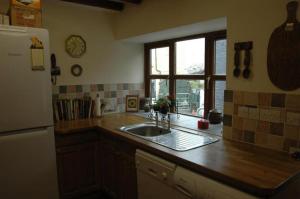 a kitchen counter with a sink and a window at Neuadd Arms Hotel in Llanwrtyd Wells