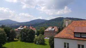 a group of houses with mountains in the background at Widok na góry in Stronie Śląskie