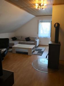 a living room with a couch and a table at Ferienwohnung Schmeisser in Kirchenpingarten