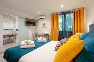 a bedroom with a large bed with towels on it at La Villa Des Sens in Lattes +19 photos
