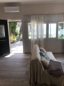a living room with a couch in front of a door at Stami's Seaside Apartment in Pyrgi