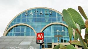 a large glass building with a m sign on it at Ostiense Suites in Rome