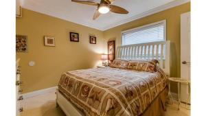 a bedroom with a bed and a ceiling fan at Holiday Villas III #311 in Clearwater Beach