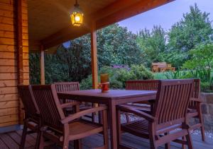 a wooden table and chairs on a porch at Ferienhaus Buchholz in Warnitz