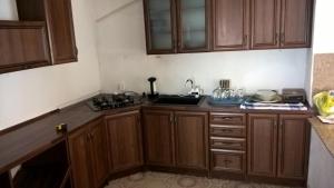 a kitchen with wooden cabinets and a sink at rodiny dom in Rapovce