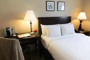 A bed or beds in a room at Capital Suites Yellowknife