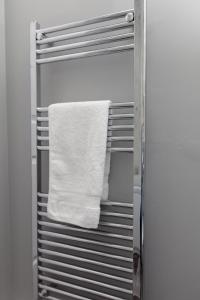 a towel hanging on a towel rack in a refrigerator at Prime Commuter Executive Apartment Dunfermline in Dunfermline