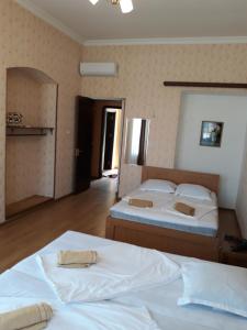 Postel nebo postele na pokoji v ubytování Guesthouse Gia