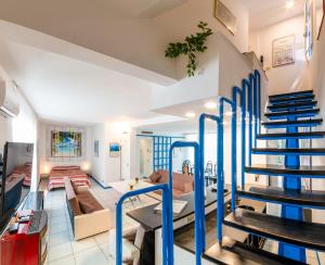 a living room with blue stairs in a house at Lignano Luxury Villa***** in Lignano Sabbiadoro