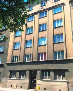 a large building with windows on the side of it at Apartment I GrayFor2 Old Town Kraków in Krakow