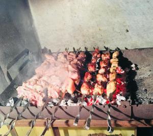 a bunch of meat cooking on a grill at Old Rabati in Akhaltsikhe