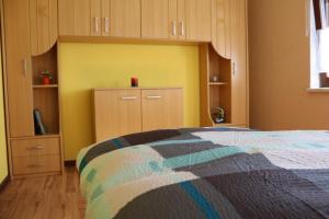 a bedroom with a bed and wooden cabinets at Ferienwohnung Gläser in Pobershau