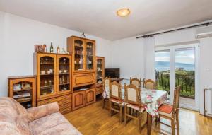 a living room with a table and a dining room at Apartment Blaza in Senj