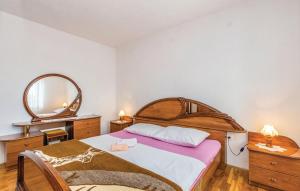a bedroom with a large bed and a mirror at Apartment Blaza in Senj