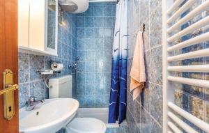 a blue tiled bathroom with a toilet and a sink at Apartment Blaza in Senj +42 photos