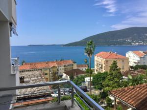 a view of a city and the ocean from a balcony at Apartment Stella Maris in Herceg-Novi