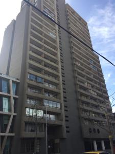 un edificio de apartamentos alto en una calle de la ciudad en Depto. Excelente vista al Cerro San Cristobal !!, en Santiago