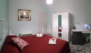 a bedroom with a red bed with towels on it at Edelweiss in Salerno