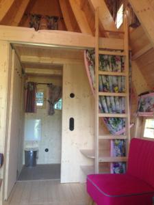 a room in a tiny house with a staircase at Hexenhäuschen am Waldrand in Annweiler am Trifels