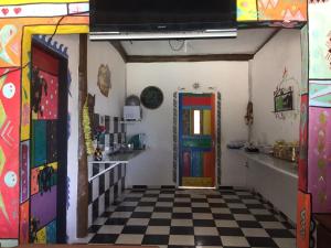 a room with a colorful door and a checkered floor at Pousada do Caboclo in Ilhabela
