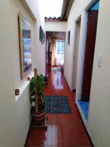 a hallway with several plants in a room at Habitación 5 minutos aeropuerto in Bogotá