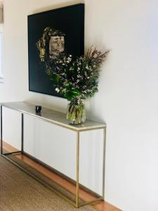 a vase of flowers on top of a table at Cable Bay Luxury Villa in Oneroa