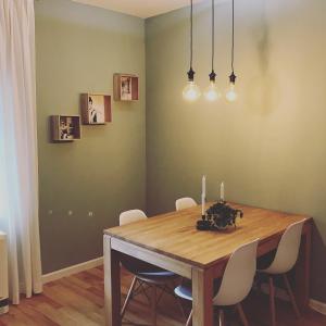 a dining room with a wooden table and chairs at City Apartment Schladming in Schladming