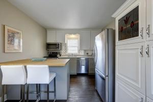 a kitchen with a refrigerator and white cabinets at Parkside House in Barrie