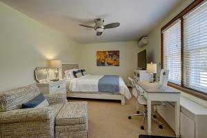 a bedroom with a bed and a desk and a couch at Parkside House in Barrie