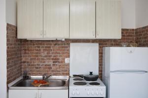 a kitchen with a stove and a white refrigerator at Apartment Star in Split