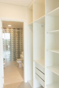 a bathroom with a toilet and a walk in closet at START Villa Morra Rent Apartments in Asuncion
