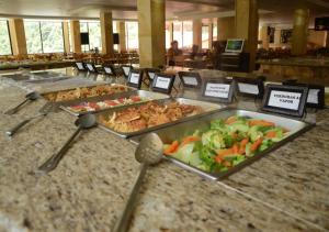 a buffet with many trays of different types of food at Hotel y Aguas Termales de Chignahuapan in Chignahuapan