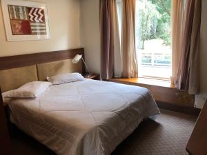 Кровать или кровати в номере Flat Luxo Mountain Village
