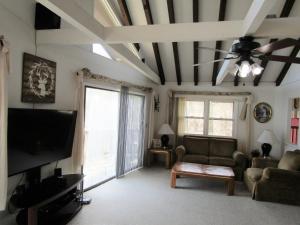 a living room with a couch and a flat screen tv at Sugar Mountain Drive 1866 Home in Sugar Mountain