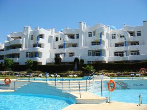 a large white apartment building with a swimming pool at Ona Campanario in La Cala de Mijas