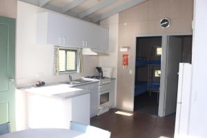 A kitchen or kitchenette at The Lakes Beachfront Holiday Park